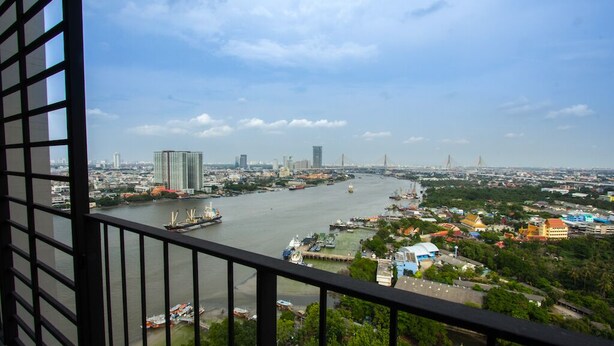 A cityscape with a river, buildings, and a bridge.