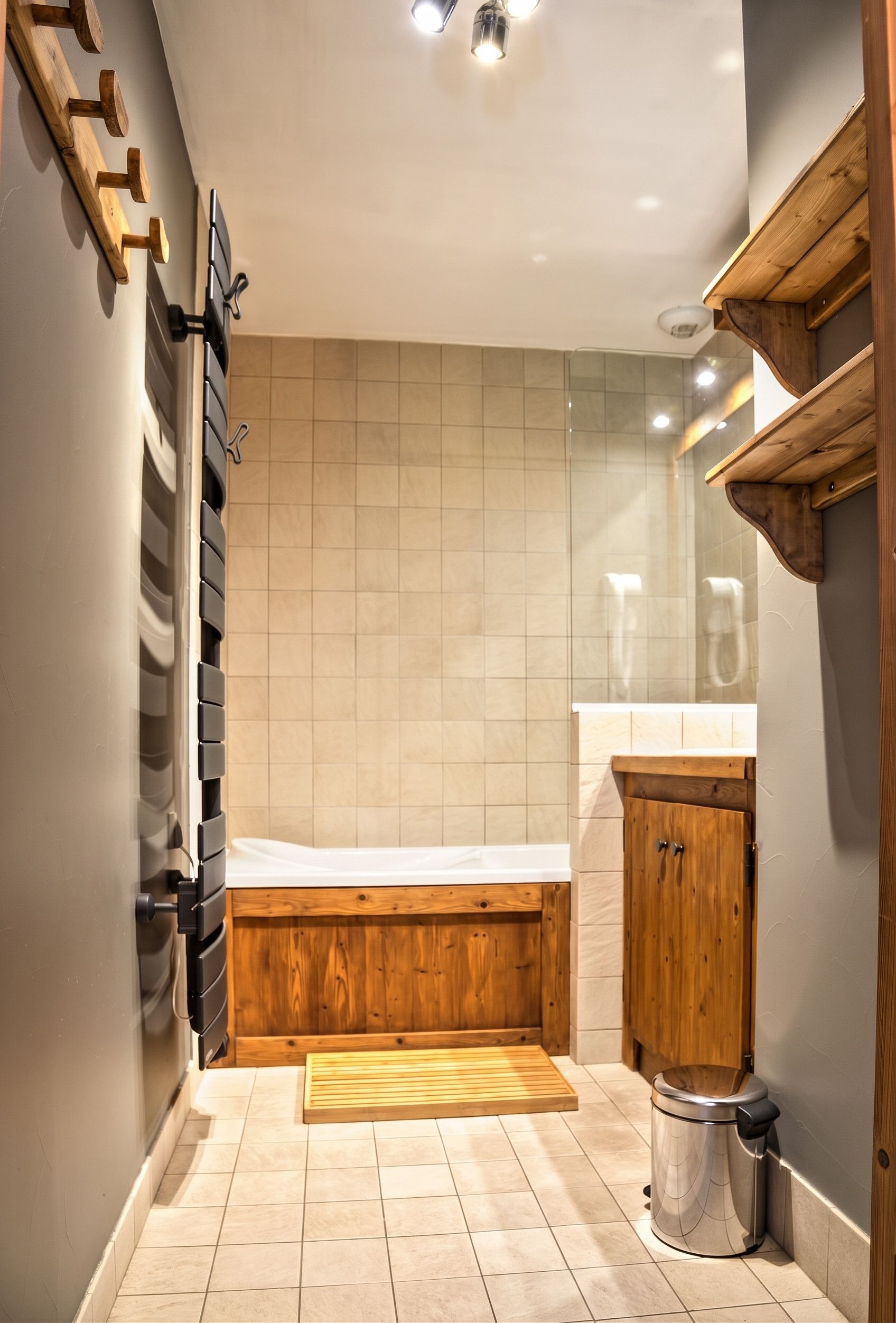 A small, compact bathroom with a wooden bench, a toilet, and a sink.