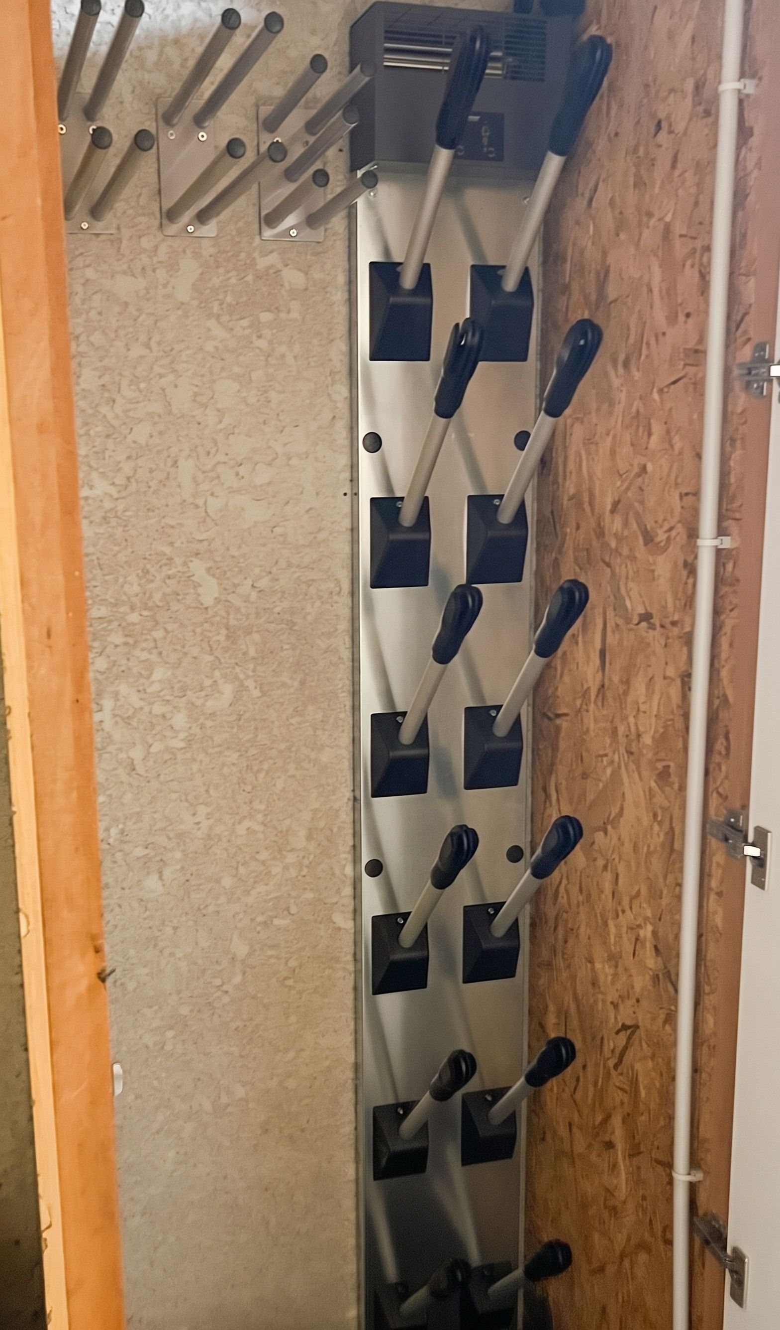 A wall-mounted rack with multiple hooks, likely for hanging coats or bags.