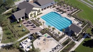 An aerial view of a resort with a large swimming pool, lounge areas, and a small building. - South Hampton 75” TV Golf Club Saint Augustine Golf Course View! (St. Augustine)