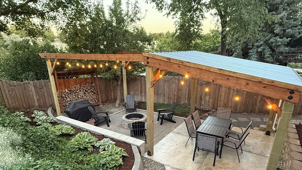A covered patio area with seating, a fire pit, and string lights. - State Street Cottage, 2BR Apt (Pullman)