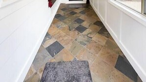 A hallway with white walls, a black door, and large windows. - State Street Cottage, 2BR Apt (Pullman)