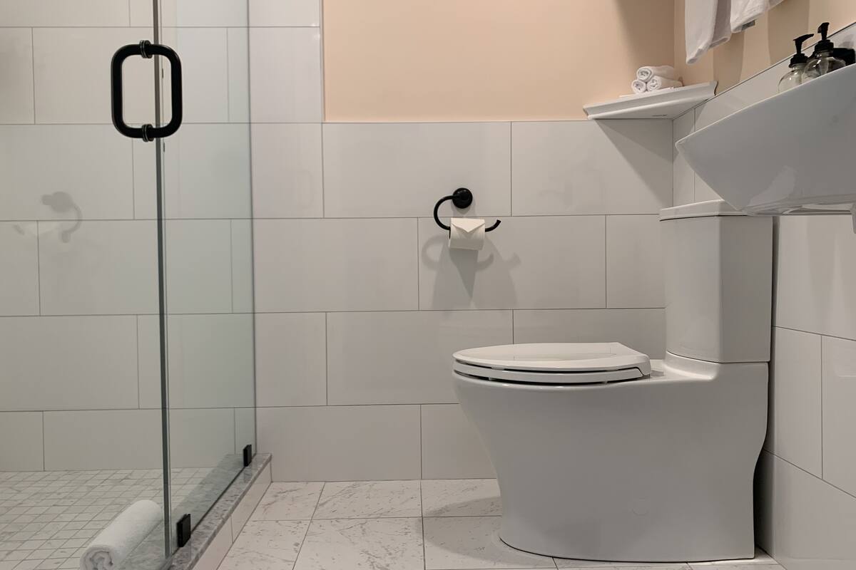 shower, rainfall showerhead, hair dryer, towels