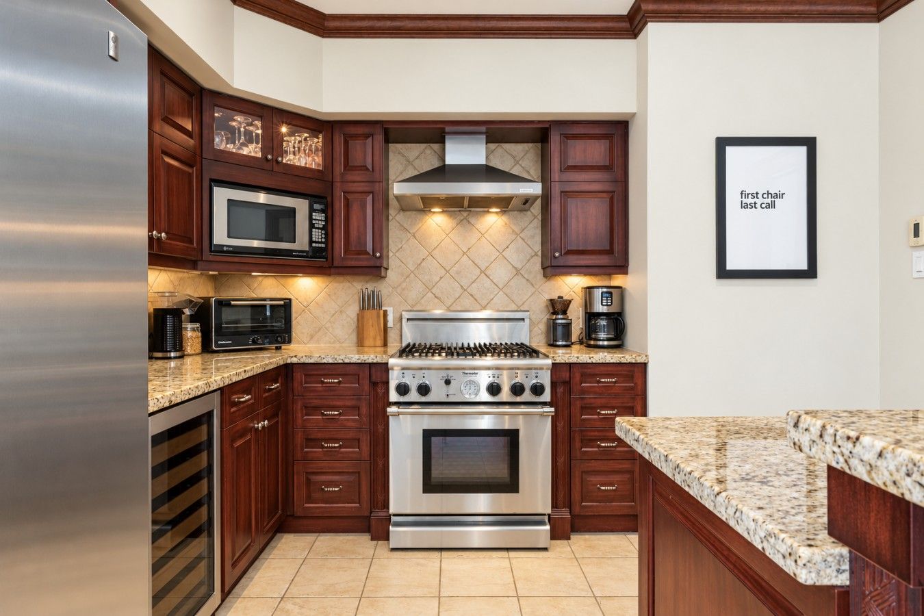 A kitchen with a stainless steel refrigerator, double ovens, a microwave, and a gas stove.