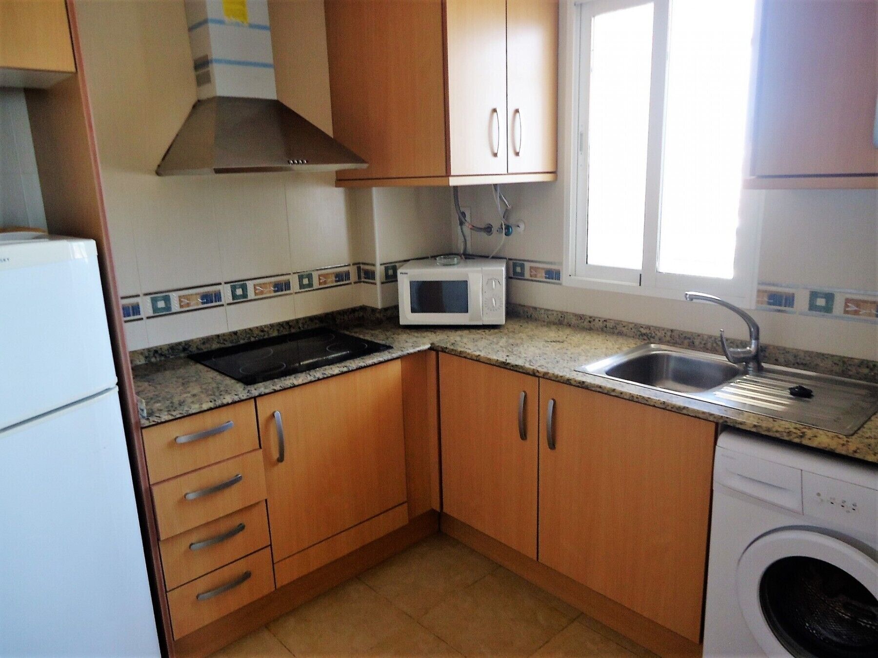 Fridge, microwave, coffee/tea maker, cookware/dishes/utensils