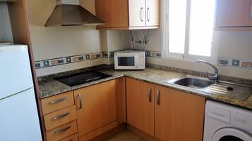 Fridge, microwave, coffee/tea maker, cookware/dishes/utensils