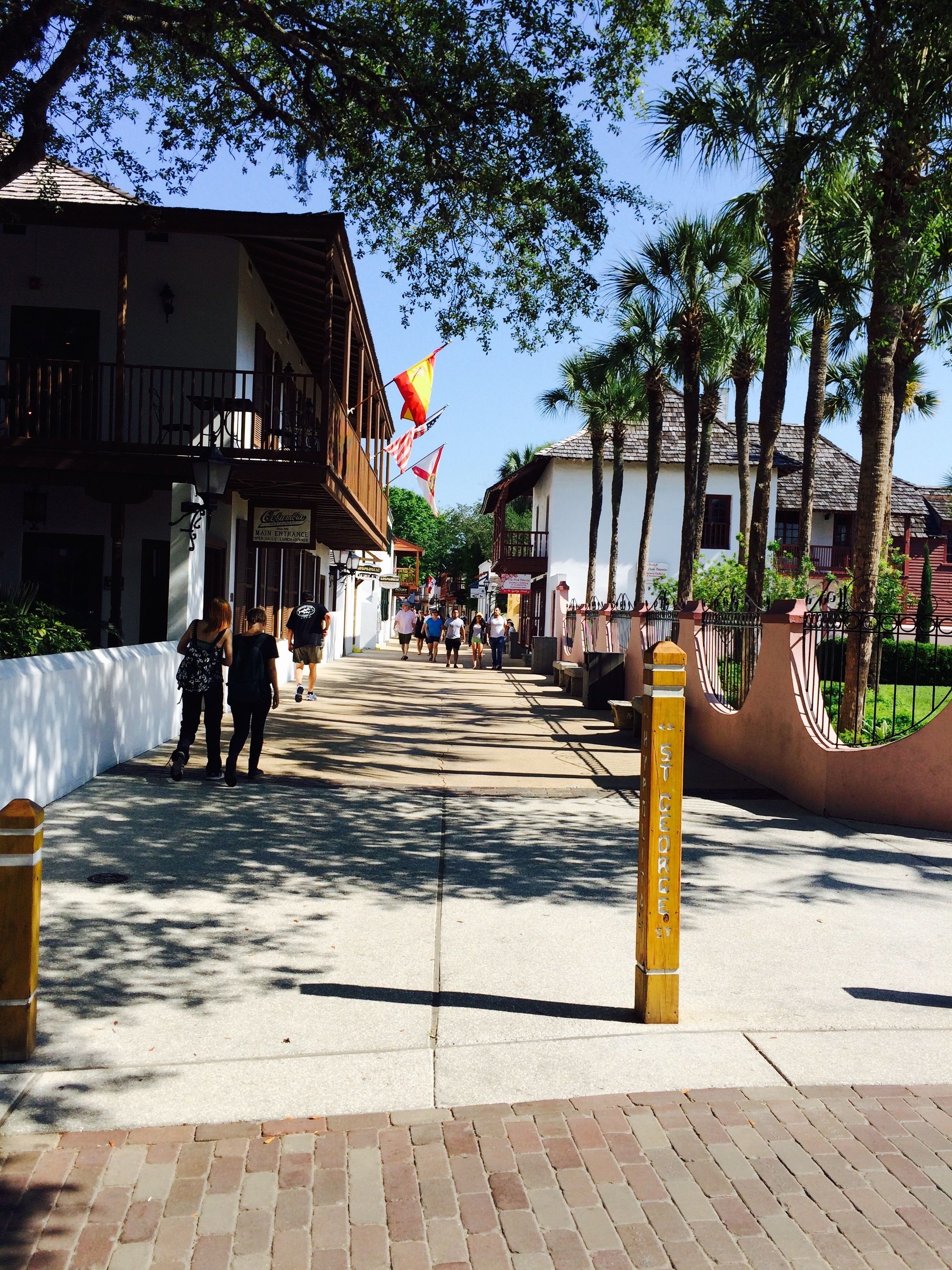 A street with buildings, palm trees, and a sign reading "St George's".