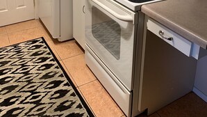 A compact kitchen with white appliances, including a refrigerator, microwave, stove, and oven. - Close To Anna Maria Island, Beaches. On IMG Golf Course. Short Drive To Sarasota (Bradenton)