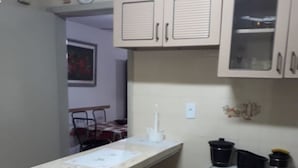 A compact kitchen with a countertop, cabinets, and a refrigerator. - Apartment 200m beach (with view), rest and comfort, close to everything. (Praia do Morro)