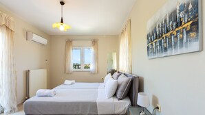 A bedroom with a large bed, a bedside table with a lamp, and a window with curtains. - Villa Carpe Diem -Luxury Villa with private pool     2 km from the beach! (Adele)