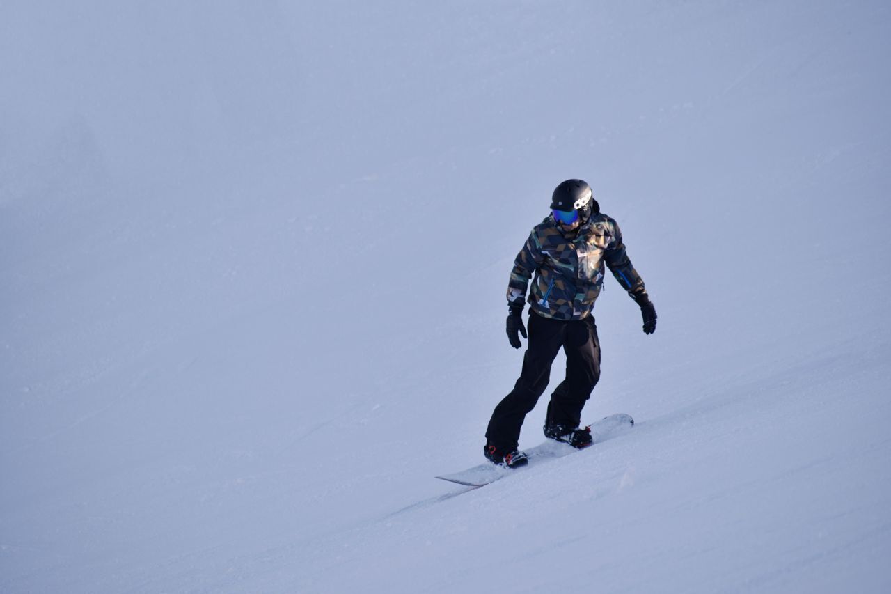 A person snowboarding down a slope.