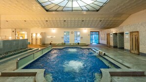 An indoor swimming pool with a skylight ceiling, a reception area, and a view of the outdoors. - Damyang Hotel (Damyang)