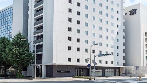 A multi-story hotel building with a prominent sign indicating it is a Super Hotel. - Super Hotel Premier Hakata Station (Fukuoka)