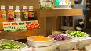 A salad bar with various vegetables and dressings. - Super Hotel Premier Hakata Station (Fukuoka)