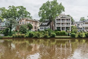 Stunning riverside homes with traditional porches and lush surroundings.