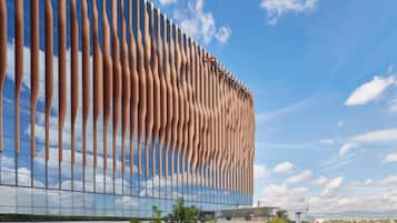 A modern building with a unique facade featuring vertical, rib-like structures.