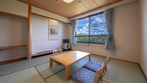 A traditional Japanese room with tatami flooring, a low wooden table, and a view of the outdoors through a large window. - Chikugofunagoya Kouennoyado (Chikugo)