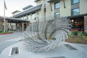 A modern building with a unique spiral metal sculpture in front. - Courtyard by Marriott Thousand Oaks Agoura Hills (Agoura Hills)