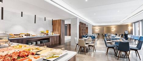 A modern dining area with a buffet, seating arrangements, and a clean, contemporary design.