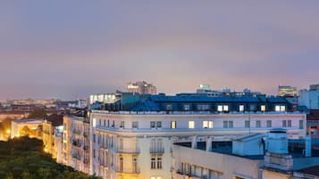 A multi-story building with balconies and a rooftop terrace.
