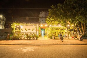 A well-lit entrance to a building with a sign that reads "MOONLIGHT HOME". - Moonlight Home (Ho Chi Minh City)