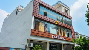 A K.K. Residency hotel with a modern facade, large windows, and a visible logo. - Itsy Hotels K K Residency Staywell (Roorkee)