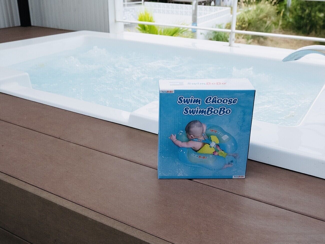 A hot tub with a SwimBoBo box on the deck.