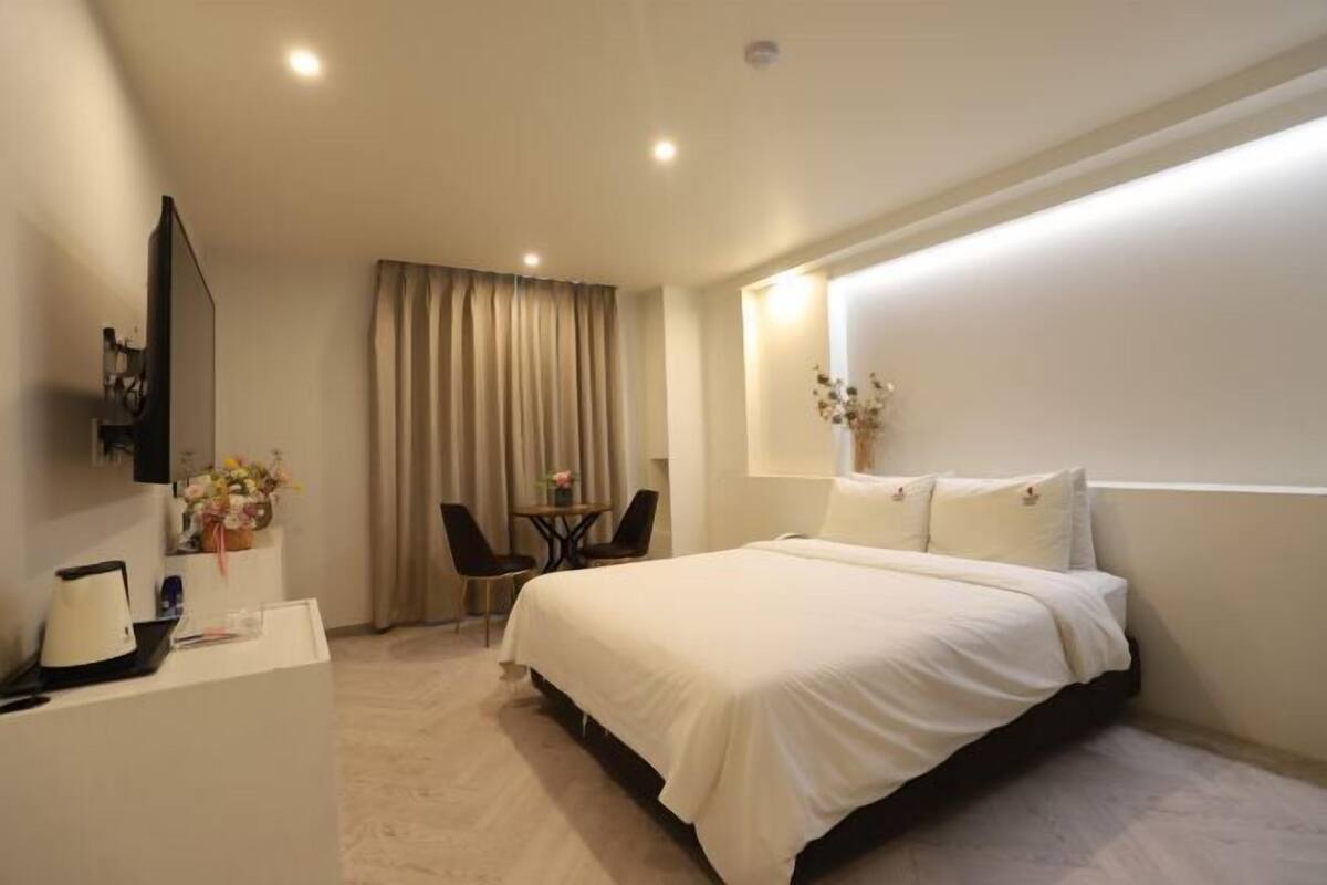 Premium bedding, desk, laptop workspace, blackout drapes