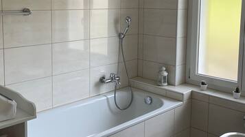 Bathtub, hair dryer, towels, soap