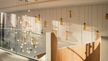 Experience a modern space with a transparent design, featuring a glass partition and wooden accents.
