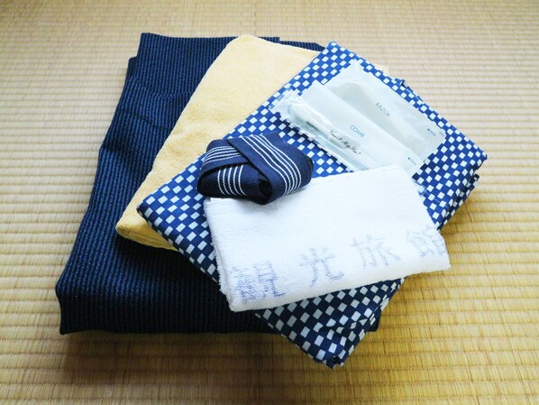 Neatly folded towels and a striped cloth on a textured surface.