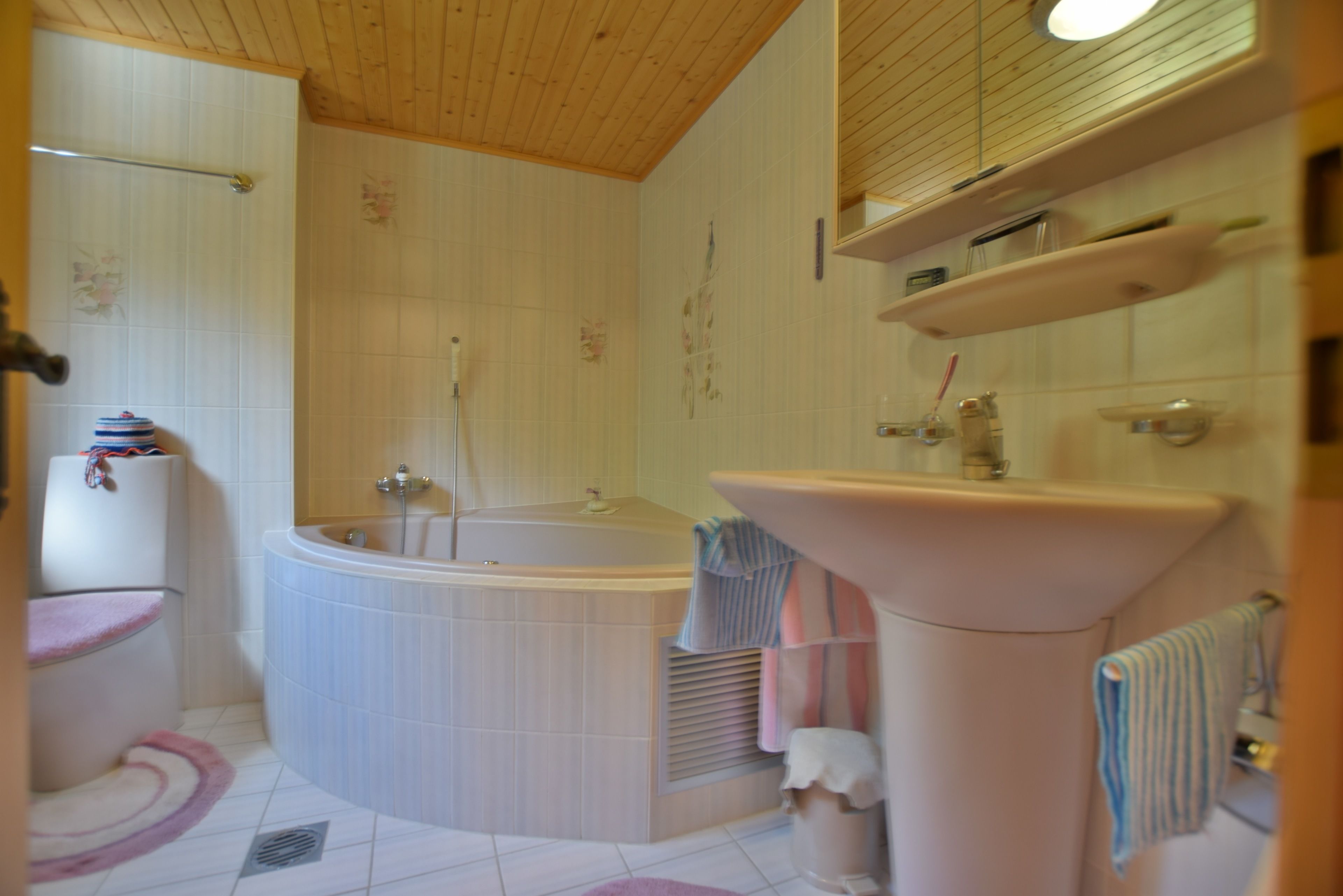 A bathroom with a bathtub, a sink, and a toilet.