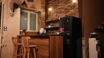 Full-size fridge, microwave, stovetop, cookware/dishes/utensils