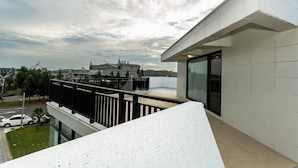 A modern building with a balcony overlooking a cityscape. - Ai Mei Homestay (Huxi)
