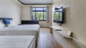 A hotel room with two beds, a TV mounted on the wall, a window with curtains, and a wooden floor. - Bo Ya Homestay (Liuqiu)