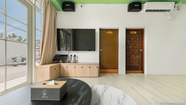 A modern hotel room with a large window, a wooden cabinet, a marble table, and a door with a sign. - Bo Ya Homestay (Liuqiu)