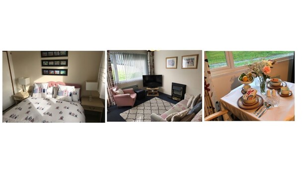 A hotel room with a bed, a TV, a fireplace, a sofa, and a dining table set for two. - Welcome to Poldark Country - A Cornish Idyll! (Camelford)