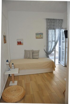 Deluxe Triple Room, Sea View | Living area | Flat-screen TV