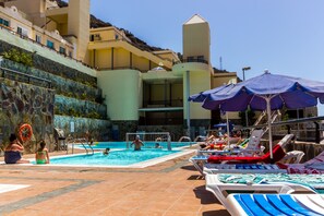 Outdoor pool, open 10:00 AM to 6:00 PM, pool umbrellas, pool loungers