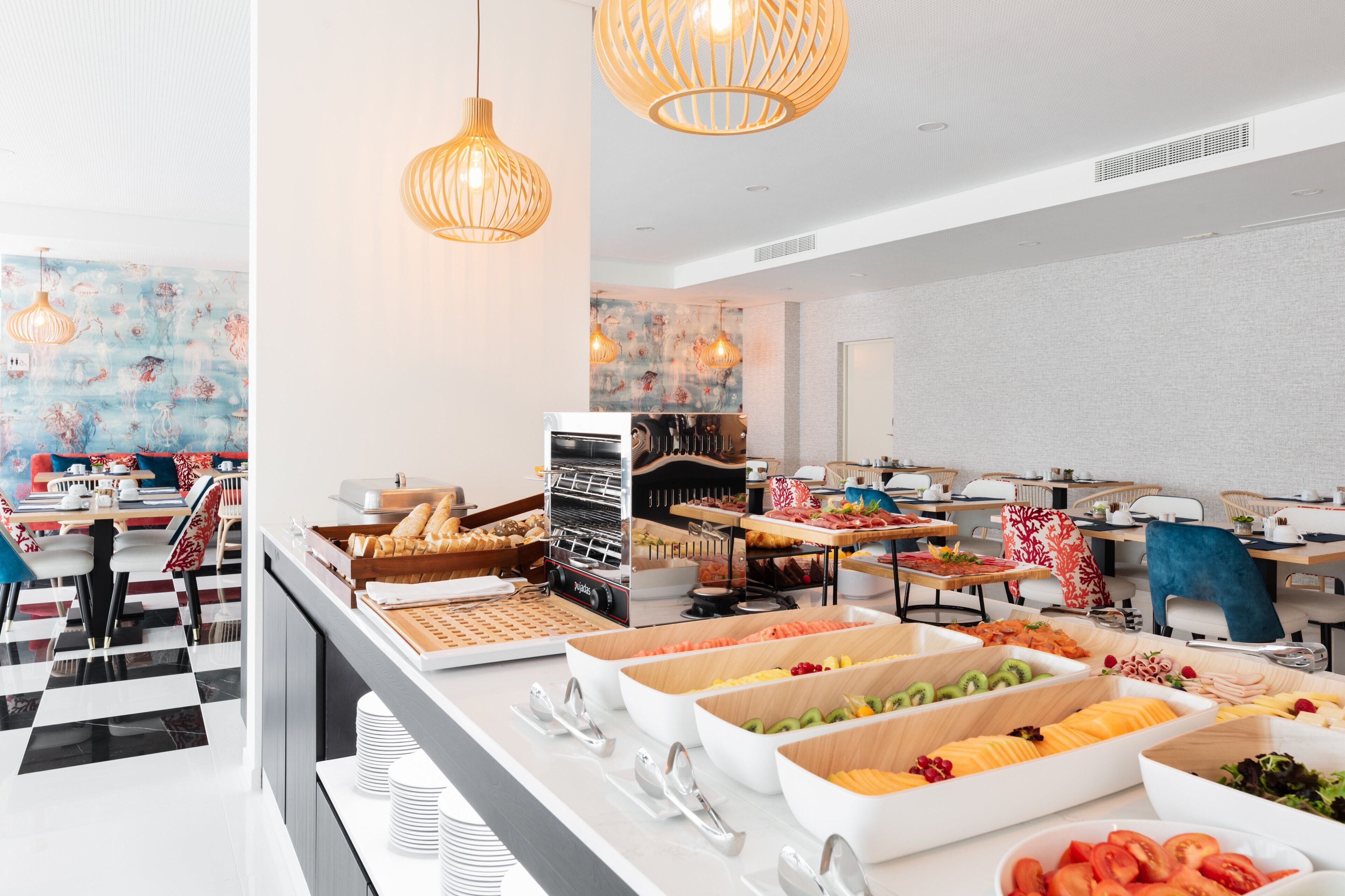 A buffet area with various food items and a seating area with tables and chairs.