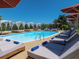 Seasonal outdoor pool, open 8:00 AM to 7:00 PM, pool umbrellas