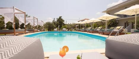 Seasonal outdoor pool, open 8:00 AM to 7:00 PM, pool umbrellas
