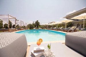 Seasonal outdoor pool, open 8:00 AM to 7:00 PM, pool umbrellas