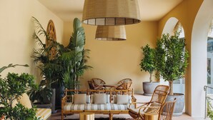 A cozy lounge area with a sofa, chairs, and a large hanging lamp. - Casa Ruffino (Bagno a Ripoli)