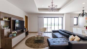 Deluxe Apartment, Multiple Beds | Living room | 38-inch flat-screen TV with cable channels, TV, Netflix