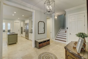 Experience a spacious interior with a large mirror, modern kitchen, and elegant rug.