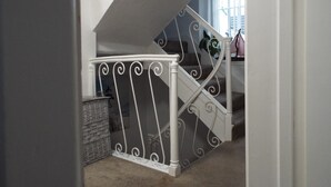 Una escalera con barandillas blancas y una pared oscura.
