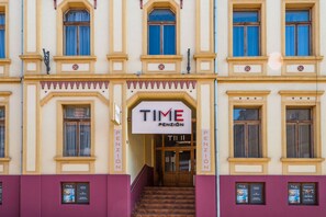 A building facade with a prominent 'TIME PENSION' sign above the entrance. - Penzion TIME (Prešov)
