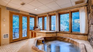 A spa area with a hot tub, large windows, and a view of the outdoors. - Ski In 3 Bedroom at Chateaux Dumont Keystone (Keystone)