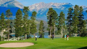 A golf course with a lake and mountains in the background. - Private 3 Bedroom Townhome Located in East Keystone With Access to a Firepit, Hot Tub, and Billiards (Keystone)